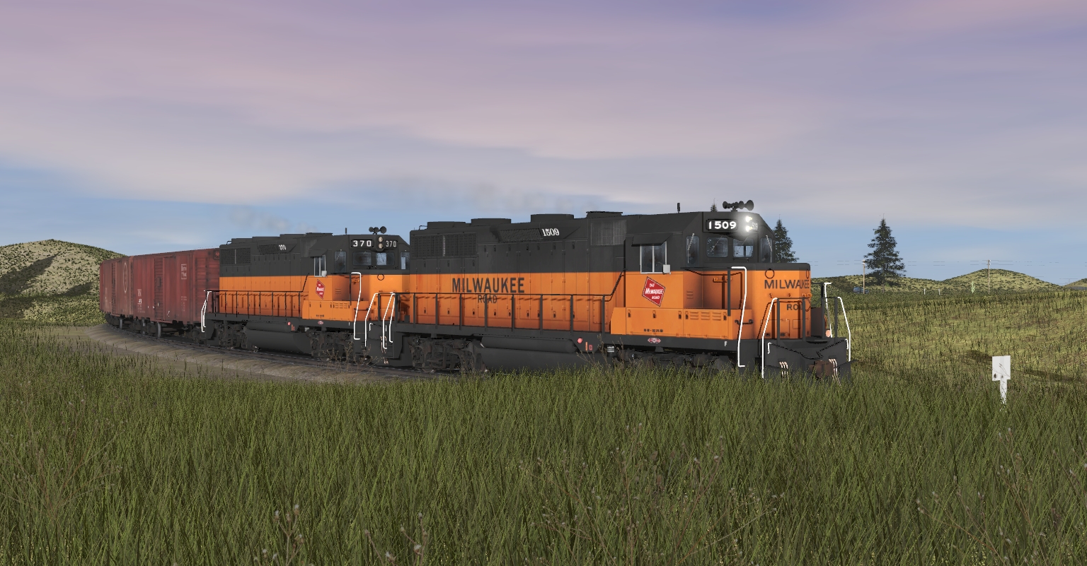 A pair of GP38-2 locomotives with a freight train passing through the American prairies on the revamped North American Plains route (known as City and Country USA)